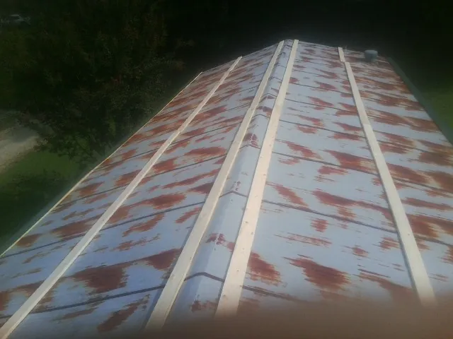 Rusted metal roof panels with new wood purlins before replacement — Storm Damage Roof Repair in Palatine by Roofing Brothers